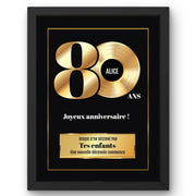 Disque d'or personnalisé pour ses 80 ans en cadre noir : grand « 80 » doré, prénom au centre du disque, signature et message au choix, livré chez vous (exemple)