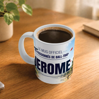 Café fumant dans le mug ball-trap posé sur un bureau en bois : la phrase « Le mug officiel des passionnés de ball-trap » et son prénom en grandes capitales, mug livré chez vous (exemple)