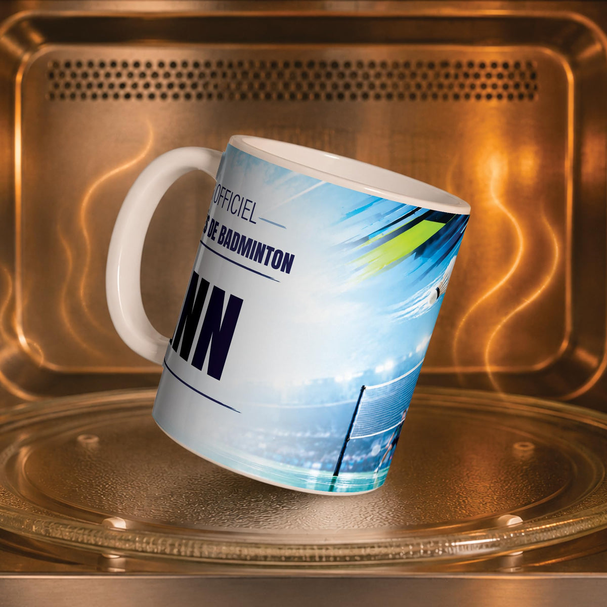 Mug badminton dans un four à micro-ondes, on y voit le volant et le filet : compatible micro-ondes, aussi en version magique révélée par la chaleur ; livré chez vous (exemple)